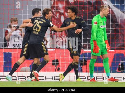 Lipsia, Germania. 12 settembre 2021. Calcio: Bundesliga, RB Leipzig - FC Bayern München, Matchday 4, alla Red Bull Arena. I giocatori di Monaco, Leroy Sané (l-r), Robert Lewandowski e Thomas Müller, dopo un gol, Peter Gulacsi, portiere di Lipsia sulla destra. Credit: Jan Woitas/dpa-Zentralbild/dpa - NOTA IMPORTANTE: In conformità con le norme del DFL Deutsche Fußball Liga e/o del DFB Deutscher Fußball-Bund, è vietato utilizzare o utilizzare fotografie scattate nello stadio e/o del match sotto forma di immagini di sequenza e/o serie di foto video-simili./dpa/Alamy Live News Foto Stock