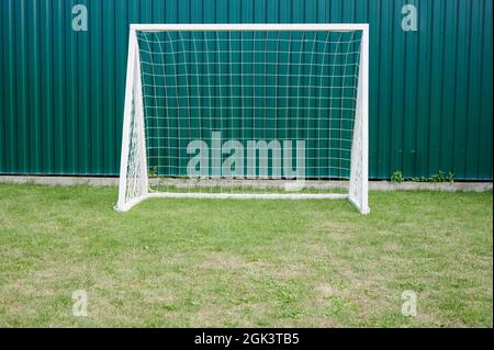 Cancello bianco vuoto sport sul campo verde erba nel parco giochi per bambini Foto Stock