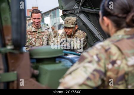 CPL dell'esercito degli Stati Uniti. Ezequiel Arjon, un meccanico veicolo gommato della 66° brigata di intelligenza militare, spiega i diversi componenti di un Humvee ai membri del 7° Squadrone del tempo di combattimento dell'aeronautica statunitense presso la Garrison dell'esercito statunitense Wiesbaden, Germania, 4 agosto 2021. Gli Airmen e i soldati hanno collaborato per allenarsi sulle abilità dei guerrieri dell'esercito come le operazioni di veicoli terrestri e convogli, le abilità di sopravvivenza ambientale e la formazione tattica di comunicazione. Il 7° CWS si attacca alle squadre delle operazioni speciali dell'esercito per fornire informazioni meteo accurate necessarie per eseguire le missioni in aria e a terra. Questa formazione lui Foto Stock