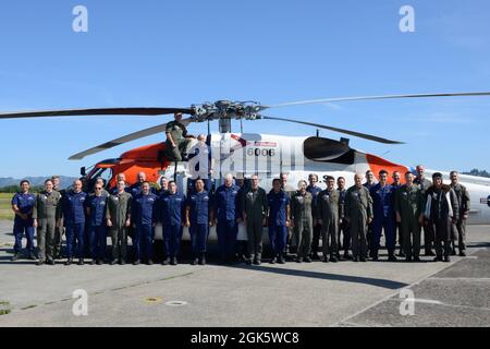 L'equipaggio della U.S. Coast Guard Air Station Astoria si assembla per una foto di gruppo con ADM posteriore. Melvin Bouboulis, 13° comandante distrettuale, 10 agosto 2021, a Warrenton, OPPURE. Ufficialmente riconosciuto come 26° Albatross antico della Guardia Costiera il 22 aprile 2021, ADM posteriore. Bouboulis (a destra) è l'aviatore commissionato dalla Guardia Costiera con la maggior parte del tempo in servizio. Foto Stock