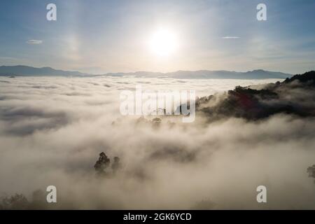 Incredibile paesaggio natura paesaggio natura vista aerea vista drone camera Fotografia di nebbia o nebbia che scorre sul picco di montagna in l'alba del mattino o su Foto Stock