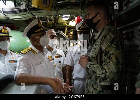 SANTA RITA, Guam (23 agosto 2021) Vice Marina indiana. ADM. Ajendra Singh, ufficiale di bandiera che comanda-in-capo, comando navale orientale, parla con CMdR. Steven Lawrence, comandante del sottomarino ad attacco rapido USS Oklahoma City di classe Los Angeles (SSN 723), durante un tour della stanza dei siluri del sottomarino, il 23 agosto. I membri della delegazione della marina indiana hanno visitato Guam e Oklahoma City. Le navi navali indiane sono nella 7a flotta per sostenere il prossimo esercizio Malabar 2021. Malabar 2021 è un esempio della partnership duratura tra le forze marittime australiane, indiane, giapponesi e americane, che r Foto Stock