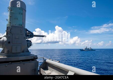 PHILIPINE SEA (agosto 24, 2021) la Royal Netherlands Navy Frigate HNLMS Evertsen (F 805) vele in formazione con la nave d'assalto anfibio dispiegata in avanti USS America (LHA 6) durante un esercizio di formazione. L'America, ammiraglia dell'America Expeditionary Strike Group, insieme alla 31st Marine Expeditionary Unit, sta operando nell'area di responsabilità della 7th Fleet statunitense per migliorare l'interoperabilità con alleati e partner e fungere da forza di risposta pronta per difendere la pace e la stabilità nella regione IndoPacifico. Foto Stock