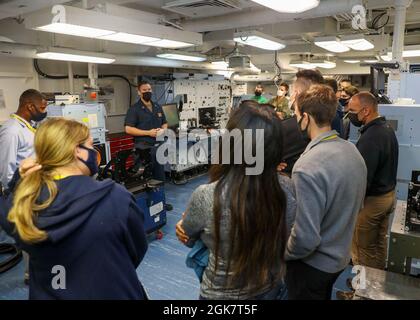 OCEANO PACIFICO (agosto 29, 2021) Aviation Electronics Technician 1st Class Allan Kerns, da San Diego, briefs Rep. Jimmy Panetta e personale congressuale durante un tour del reparto di manutenzione intermedia dell'aeromobile a bordo della portaerei USS Abraham Lincoln (CVN 72). Abraham Lincoln sta attualmente conducendo le qualifiche del vettore nell'area di operazioni della terza flotta degli Stati Uniti. Foto Stock