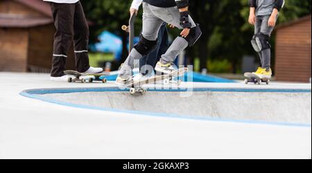 Close up of a skateboarders feet while skating on concrete at the skate park Stock Photo