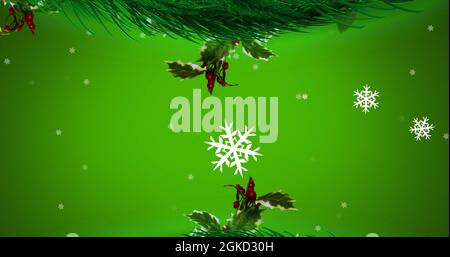 Immagine digitale della corona di natale decorazione fiocchi di neve che si muovono su sfondo verde Foto Stock