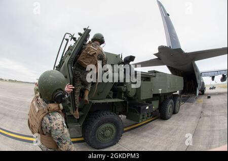 I Marines della 24a unità Marine Expeditionary si preparano a caricare un sistema a razzo per artiglieria ad alta mobilità (HIMARS) su un MC-130J Commando II assegnato alla 352d Special Operations Wing alla RAF Mildenhall il 24 marzo 2021. Le capacità di Special Operation migliorano l'esecuzione delle missioni di inserimento aereo rapido HIMARS, estendono la portata delle capacità di colpo di precisione a lungo raggio e consentono la forza congiunta. Foto Stock