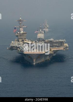 OCEANO INDIANO (28 marzo 2021) – la portaerei USS Theodore Roosevelt (CVN 71), di fronte, l'incrociatore missilistico guidato classe Ticonderoga USS Bunker Hill (CG 52), di mezzo, la fregata missilistica guidata classe Shivalik della Marina indiana IN Shivalik (F47), di dietro, E il cacciatorpediniere missilistico guidato di classe Arleigh Burke USS Russell (DDG 59), veleggia in formazione il 28 marzo 2021. Il gruppo Theodore Roosevelt Carrier Strike è in fase di dispiegamento programmato per l'area operativa della 7a flotta statunitense. Come la più grande flotta della Marina statunitense, 7th Fleet opera regolarmente e interagisce con 35 nazioni marittime Foto Stock