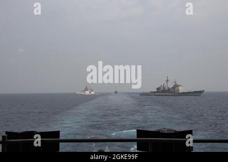 OCEANO INDIANO (28 marzo 2021) – la fregata missilistica guidata della Marina indiana Shivalik-class IN Shivalik (F47), a sinistra, l'incrociatore missilistico guidato di classe Ticonderoga USS Bunker Hill (CG 52), Middle, la e la cacciatorpediniera missilistica guidata di classe Burke USS Russell (DDG 59), in formazione dietro la nave da trasporto velica CVS 71 (USN Roosevelt) Marzo 28, 2021. Il gruppo Theodore Roosevelt Carrier Strike è in fase di dispiegamento programmato per l'area operativa della 7a flotta statunitense. Come la flotta più grande della Marina statunitense, 7th Fleet opera e interagisce di routine con 35 nazioni marittime wh Foto Stock