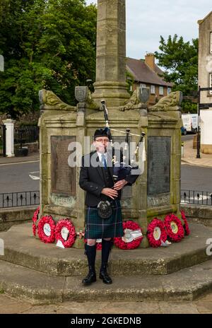 Un piper suona le cornamuse al monumento commemorativo di guerra commemora il giorno di San Valery quando i soldati scozzesi sono stati catturati nella seconda guerra mondiale, Berwick settentrionale, Scozia, Regno Unito Foto Stock