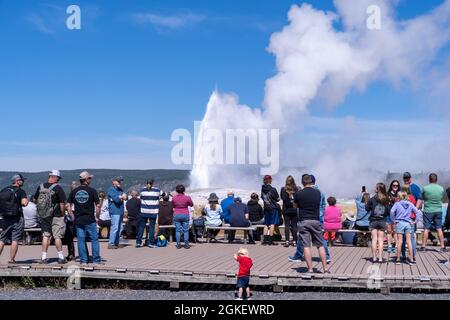 Wyoming, USA - 10 agosto 2021: Folle di turisti aspettano lungo le passerelle per far esplodere Old Faithful nel Parco Nazionale di Yellowstone Foto Stock