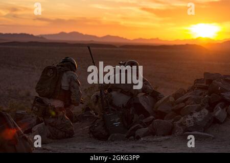 Andrew Piech (sinistra), un controller di attacco terminale congiunto (JTAC) e Sgt. Dylan Griffin, un operatore radio assegnato al team C di collegamento delle armi di supporto, 2nd Brigade Platoon, 1st Air Naval Gunfire Liaison Company, i Marine Expeditionary Force Information Group, USA un Rangefinder di Designator leggero portatile per coordinare il supporto in aria stretta durante un'evoluzione di formazione integrata con il 56o Gruppo operativo dell'aeronautica statunitense e le forze armate lituane sulla base dell'aeronautica Gila Bend, Ariz., 13 aprile 2021. Le JTAC guidano gli attacchi aerei da terra mentre si allenano con i piloti da t Foto Stock