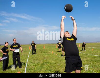 SGT. Prima classe Jonathan Peters, un soldato con truppa A, 1 ° Squadron, 113 ° reggimento di cavalleria, Iowa Army National Guard, esegue il tiro in piedi potere durante un corso di certificazione Army Combat Fitness Test 3.0 a Camp Bondsteel, Kosovo, il 29 aprile 2021. Il potere in piedi misura il potere esplosivo di un soldato ed è eseguito con una palla medica da 10 libbre. Foto Stock