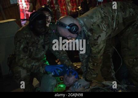 Tecnologia. SGT. Dillon Wright, left, e Senior Airman Joshua Egler, a destra, entrambi i tecnici medici del 18° Squadrone di evacuazione Aeromedica, eseguono RCP e respirazione assistita su un paziente simulato da manichino in un KC-135 Stratotanker del 909° Squadrone di rifornimento aereo, della base aerea di Kadena, Giappone, volando sul mare giapponese, 5 maggio 2021. Il 18 AES ha anche la capacità di utilizzare le loro competenze mediche su altri aerei se la situazione lo richiede. Il 18 AES è composto principalmente da Airmen che si offrono volontariamente per questo speciale dovere che richiede loro di essere altamente addestrati e qualificati. Foto Stock