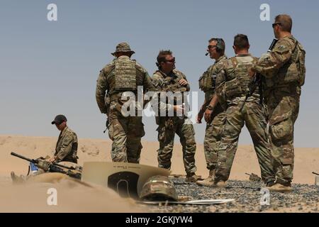 Soldati dell'esercito degli Stati Uniti assegnati alla D Company 3-172 fanteria di montagna, il Valor di ferro della Task Force, parlano fra loro mentre ad una gamma di fucili vicino a Camp Buehring, Kuwait, 9 maggio 2021. Durante un'esercitazione di due giorni sul fuoco dal vivo, i soldati hanno addestrato su armi individuali e sistemi di armi serviti dall'equipaggio. Foto Stock