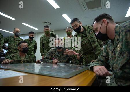 Marines con III forza di spedizione marina e soldati con 1° reggimento di dispiegamento rapido anfibio, condurre la pianificazione della missione durante un esercizio del personale per l'esercizio Jeanne D'Arc 21, Camp Ainoura, Sasebo, Giappone, 12 maggio, 2021.durante l'esercizio del personale, i leader di ciascuna forza condividono le procedure di pianificazione in preparazione allo svolgimento di eventi di formazione sul campo. ARC-21 è un'opportunità per le forze statunitensi, francesi, giapponesi e australiane di condividere esperienze, tattiche e Best practice per affinare insieme le proprie competenze. Foto Stock