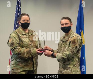 Il Senior Airman dell'aeronautica statunitense Alexander Lundy, 21st Special Tactics Squadron, riceve un certificato di laurea dal Commandants Award del Master Sgt. Alicia Powell, Comandante, CMSgt Louis Williams Airman Leadership School, Pope Army Airfield, NC. La presentazione è stata parte della cerimonia di laurea per la Classe 21-D del Master superiore Sgt. Louis Williams Airman Leadership School at Pope Army Airfield, North Carolina, 13 maggio 2021. Foto Stock