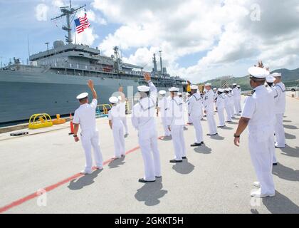 BASE NAVALE GUAM (20 maggio 2021) marinai assegnati alla gara sottomarina USS Emory S. Land (AS 39) ondano a marinai a bordo della nave mentre ormola al molo a bordo della base navale statunitense Guam, maggio 20. La terra tornò a casa a Guam dopo un periodo di otto mesi di manutenzione programmata al Mare Island Dry Dock a Vallejo, California. Foto Stock