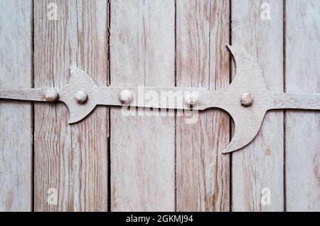 Frammento di porta in legno con cerniera in metallo arrugginito Foto Stock