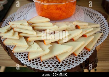 Arrangiamento di fette di formaggio paprika affumicato a metà. Primo piano Foto Stock