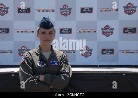 Il primo tenente Samanda McGiffin, un membro del 164esimo Squadrone Airlift alla 179esima Ala Airlift, si pone di fronte al palco principale al Mid-Ohio Sports Car Course il 5 giugno 2021. McGriffin ha servito come controllo di terra durante il volo sopra e ha comunicato con l'equipaggio nell'aereo per temporizzare il volo sopra con l'esecuzione dell'inno nazionale. Foto Stock