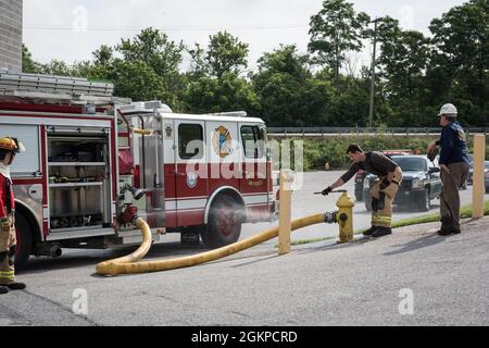 Un vigile del fuoco con il 193a Special Operations Civil Engineer Squadron, Pennsylvania Air National Guard, collega il loro veicolo ad una fonte d'acqua 12 giugno 2021 alla York County Fire School di York, Pennsylvania. I vigili del fuoco della Pennsylvania Air e della Guardia Armata hanno lavorato insieme per condurre vari scenari di addestramento antincendio dal vivo. Foto Stock