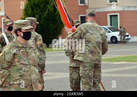 John L. Harrell, comandante uscente del 509° Battaglione segnale strategico, passa i colori al col. Michael R. Kaloostian, comandante della 2a Brigata segnale teatrale, durante la cerimonia di cambio comando sotto la condizione di prevenzione di Covid-19 a Caserma del DIN, Vicenza, Italia 17 giugno 2021. Foto Stock