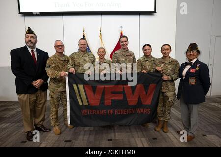 Matthew McCoy, giudice di stato per i veterani di Rhode Island delle guerre estere, si trova accanto al col. David Ashley, il col. Matthew Edwards, il Major. Joanne Barrett, il Capt. Regan Keenan, il personale Sgt. Jessica Godena, staff Sgt. Nicole Mackay e Dora Vasquez-Hellner, Comandante di Stato del RI VWA, intrattiene un veterano delle guerre estere, 30 giugno 2020, Camp Fogarty, East Greenwich, RI. La cerimonia premia i membri del servizio che hanno dimostrato e sostenuto una leadership superiore mentre prestavano servizio nella comunità medica della Guardia Nazionale del Rhode Island. Foto Stock