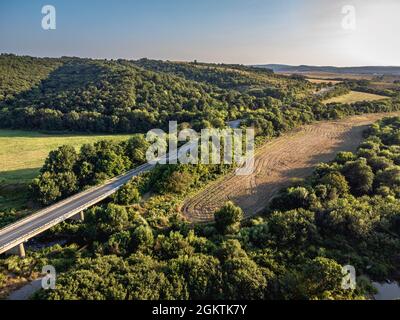 Strada che attraversa i terreni agricoli della Bulgaria orientale Foto Stock