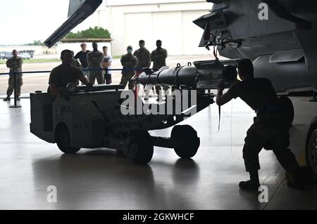 Le armi dell'aeronautica degli Stati Uniti caricano i membri dell'equipaggio dal 33th Aircraft Maintenance Squadron competono in una competizione trimestrale di carico di armi 9 luglio 2021, alla base dell'aeronautica di Eglin, Florida. Gli Airmen hanno consegnato MISSILI aria-aria di gamma media avanzata AIM-120 e bombe GBU-12 nelle baie delle armi di due aerei da combattimento F-35A Lightning II durante una competizione di carico temporizzata e graduata. Foto Stock