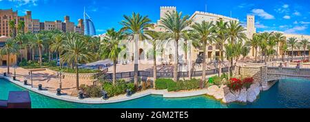 Il canale e il vicolo delle palme del complesso Souk Madinat Jumeirah di fronte al Centro Congressi ed Eventi di Madinat Jumeirah, Burj al Arab e Jumeirah min Foto Stock