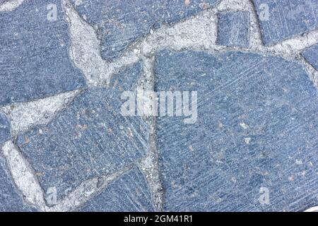 Pietre di pavimentazione. Tessitura di pietra. Strada di pietra. Pietra mosaico. Foto Stock