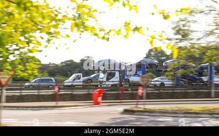 Le automobili Tesla caricano sopra ad un grande trasporto dell'automobile guidano sulla M27 a Rownhams vicino Southampton visto in un colpo di panning. Foto Stock