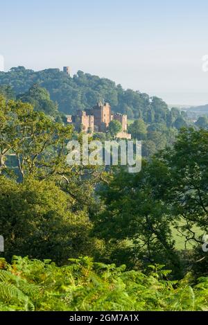 Il castello di Dunster e la Torre di Conygar si ammirano dal Dunster Park ai margini dell'Exmoor National Park, Somerset, Inghilterra. Foto Stock