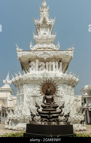 Chiang Rai, Thailandia - 16 febbraio 2020. Statua e palazzo al Tempio Bianco Buddhista Tailandese Wat Rong Khun nel nord della Thailandia. Attrazione turistica asiatica. Foto Stock