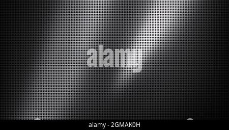 Piastra metallica forata con luce spot. Primo piano su sfondo metallico Foto Stock