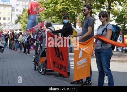 Duisburg, Germania. 18 settembre 2021. I cittadini di Duisburg formano una catena umana nel centro della città. Le organizzazioni avevano chiesto l'azione "Rescue Rings for Human Rights" (anelli di salvataggio per i diritti umani). Già nel 2020, un'azione a livello nazionale consisteva nel formare una catena di salvataggio da Amburgo a Stoccarda fino al Mar Mediterraneo, al fine di richiamare l'attenzione sui diritti umani dei rifugiati alle frontiere esterne dell'Unione europea e nel Mar Mediterraneo. A causa di Corona, gli anelli di salvataggio sono ora in fase di formazione al posto di una catena umana. Credit: Roberto Pfeil/dpa/Alamy Live News Foto Stock