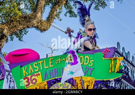 Una donna lancia le perle del Mardi Gras durante la parata del Mardi Gras del giorno del Caino del Joe, 26 febbraio 2017, a Mobile, Alabama. Foto Stock