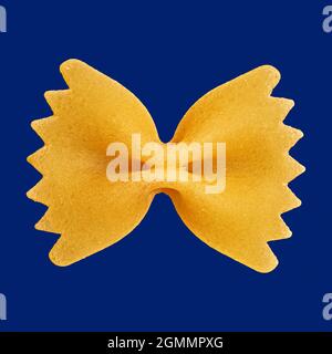 Primo piano su spaghetti di farfalle bowtie non cotti su sfondo blu Foto Stock