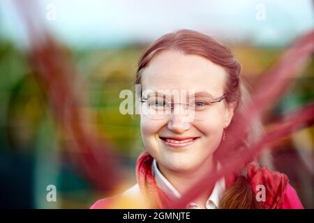 Ritratto di giovane donna europea sorridente con occhiali da diottro. Foto Stock