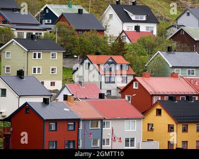 HonningsvŒg è la città più settentrionale della Norvegia e si trova all'interno del Circolo polare Artico. Qui vediamo alcune delle molte case di legno multicolore di fronte al suo har Foto Stock