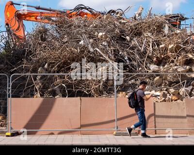 Oxford, Inghilterra - 23 agosto 2019; un uomo che passa vicino. Un edificio demolito in un cantiere in Norfolk Street, di fronte a Westgate in Oxford, Foto Stock