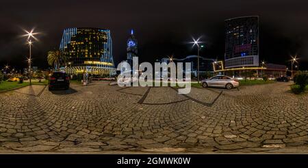 BATUMI, GEORGIA - SETTEMBRE 2021: Panorama notturno sferico senza giunture 360 gradi angolo di vista area dei moderni grattacieli e uffici in apparecchiature Foto Stock