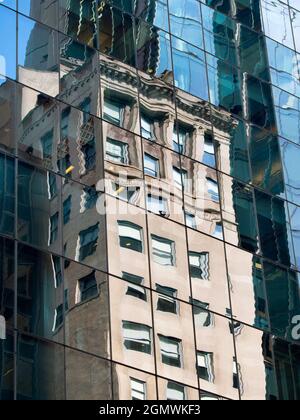 New York, USA - 3 novembre 2013; nessuna gente in vista. I riflessi distorti dei grattacieli rimbalzano intorno a questo canyon di strada archetipo a Manhattan. Plu Foto Stock