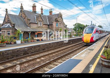 Treno elettrificato Azuma che passa attraverso la stazione ferroviaria di Chathill, classificata di grado 2, sulla linea principale della costa orientale. Foto Stock