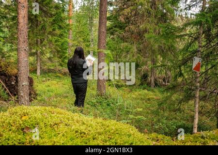 Attività del punto di controllo dell'orienteering all'aperto: Donne che guardano la mappa, vista posteriore Foto Stock