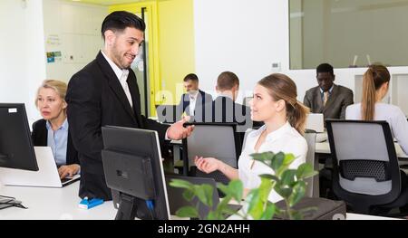 Colleghi che girano in un ufficio moderno Foto Stock