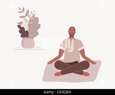 Uomo afro-americano seduto con le gambe incrociate sul pavimento e meditante. Ragazzo giovane in posizione di yoga che fa la meditazione, pratica di consapevolezza Foto Stock