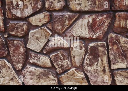 Parete in pietra intarsiata in ordine che forma un decorativo Foto Stock