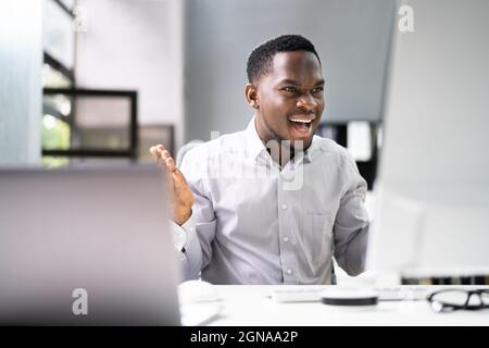 Shocked African Man con ransomware su computer Office Foto Stock